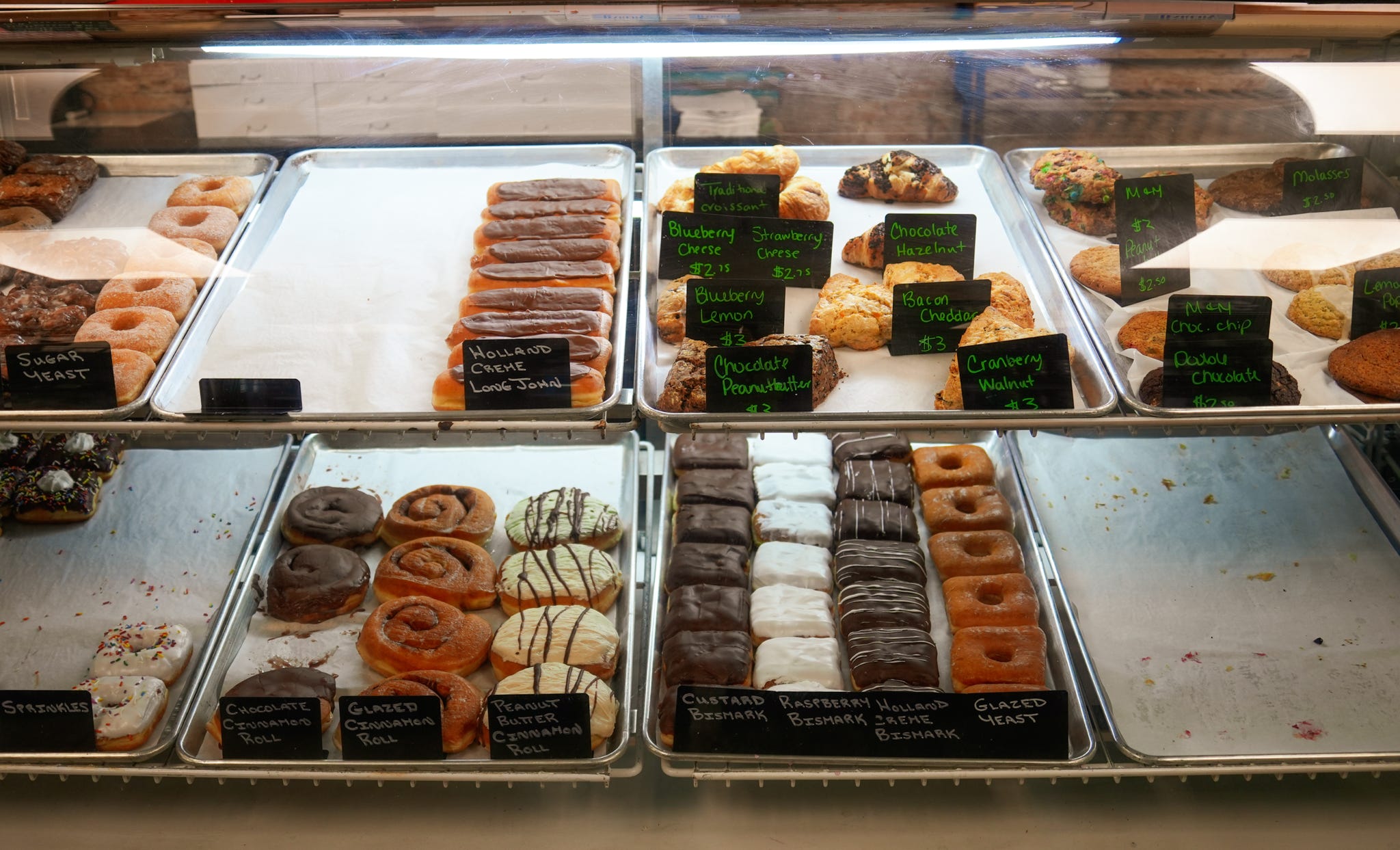 Bakery case filled with scones, cinnamon rolls and pastries